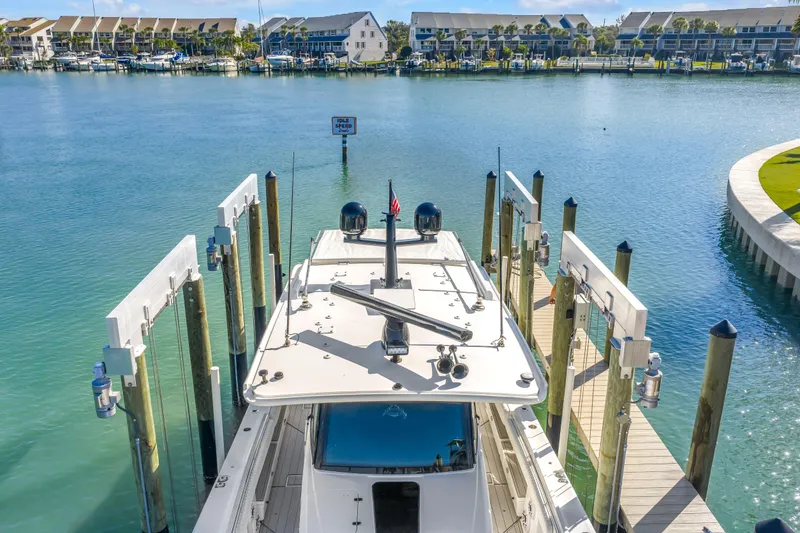 Slide: The Image of 2023 HCB 53 Suenos RXV docked in a serene marina setting. - 4