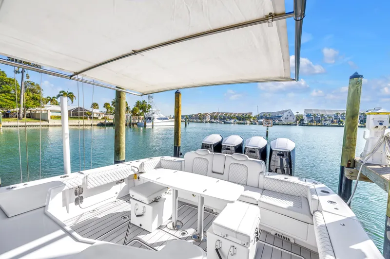 Slide: The Image of 2023 HCB 53 Suenos RXV luxury boat interior with seating and outboard motors. - 50