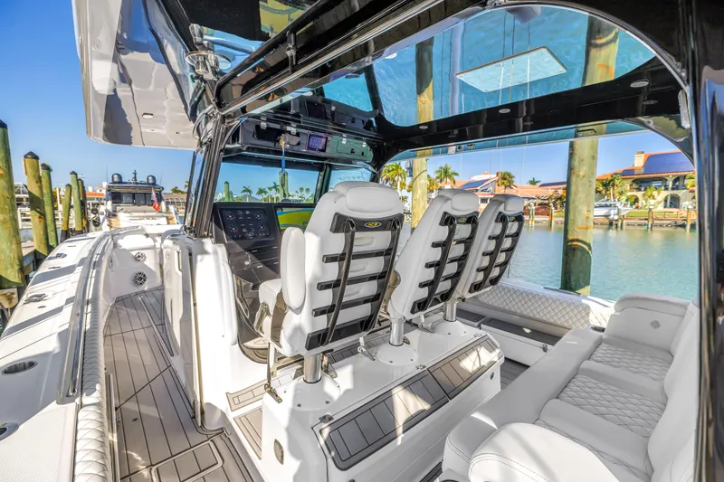 Slide: The Image of Luxurious 2023 HCB 53 Suenos RXV boat interior with plush seating and modern dashboard. - 53