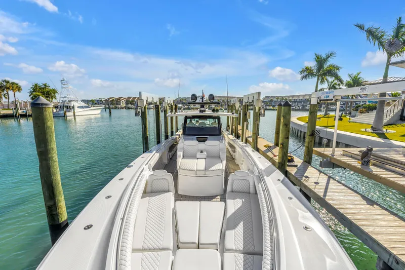 Slide: The Image of 2023 HCB 53 Suenos RXV luxury boat docked in a sunny marina setting. - 55