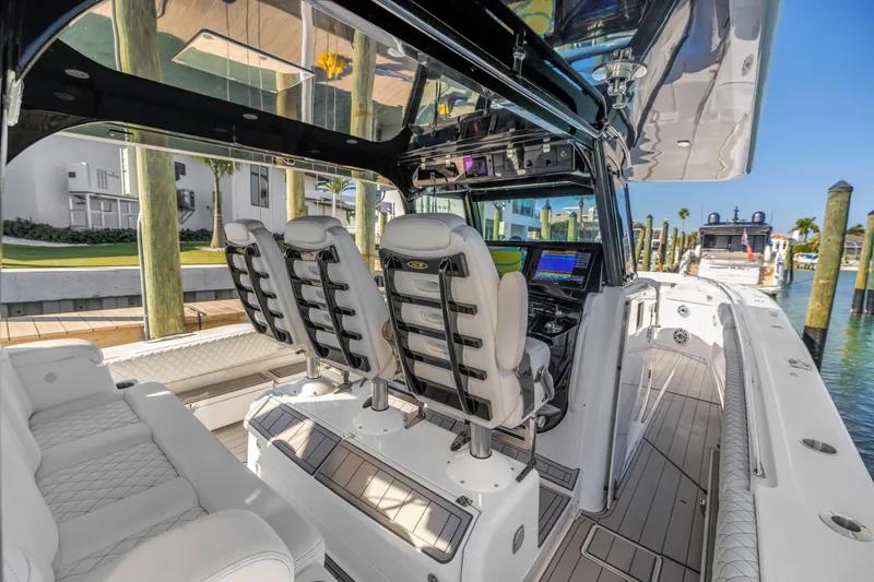 Slide: The Image of 2023 HCB 53 Suenos RXV luxury boat interior with modern seating and navigation equipment. - 56