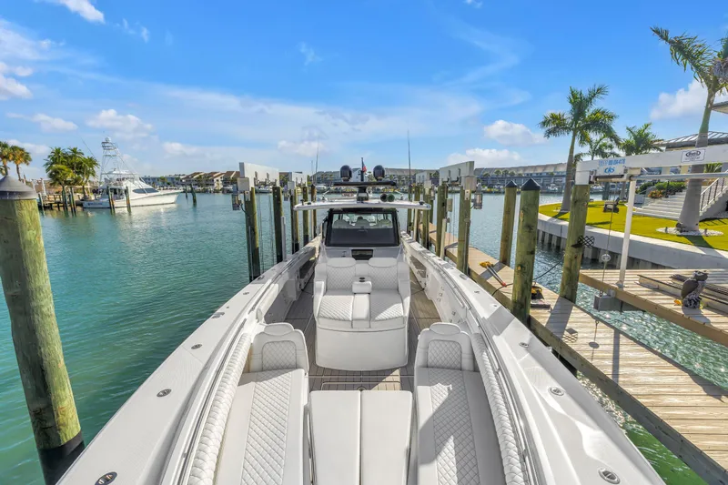 Slide: The Image of 2023 HCB 53 Suenos RXV luxury boat docked in a sunny marina setting. - 57