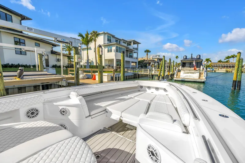 Slide: The Image of Luxurious 2023 HCB 53 Suenos RXV boat docked in a sunny marina setting. - 59