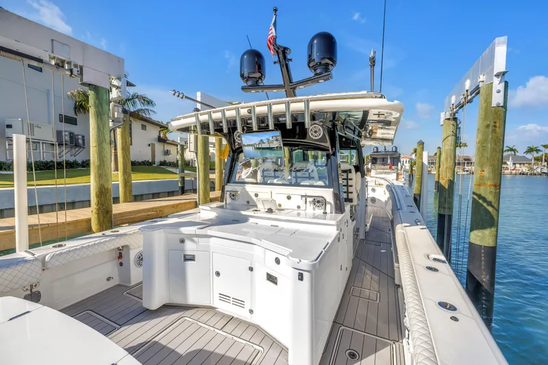 Slide: The Image of 2023 HCB 53 Suenos RXV luxury boat docked at marina under clear blue sky. - 68