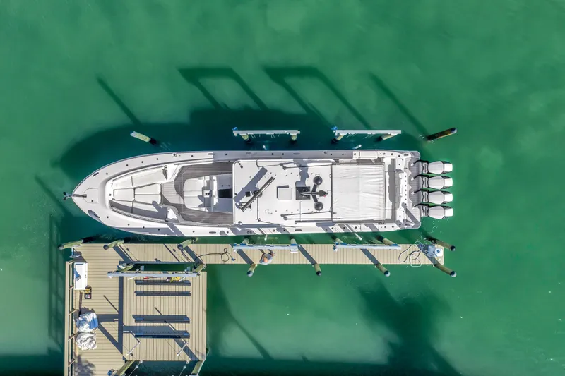 Slide: The Image of Aerial view of 2023 HCB 53 Suenos RXV boat docked in turquoise water. - 7