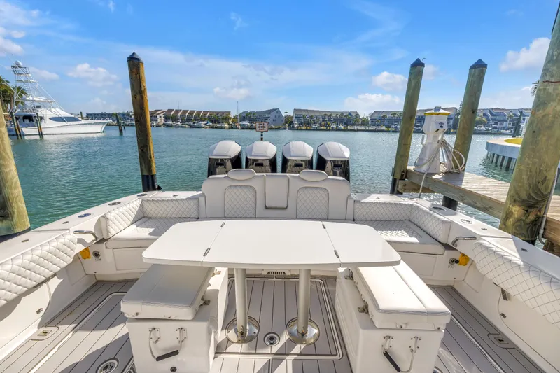 Slide: The Image of 2023 HCB 53 Suenos RXV boat interior with seating and table, docked in marina. - 71