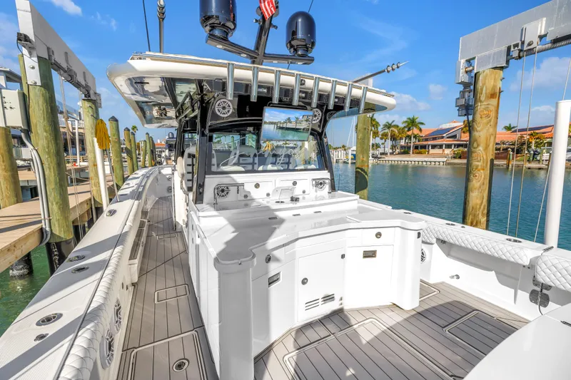 Slide: The Image of 2023 HCB 53 Suenos RXV luxury boat docked at marina under clear blue sky. - 74