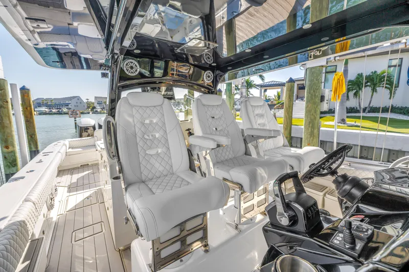 Slide: The Image of 2023 HCB 53 Suenos RXV boat interior with luxurious seating and modern controls. - 82