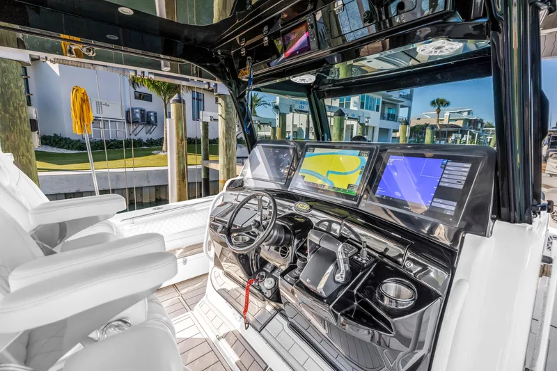 Slide: The Image of 2023 HCB 53 Suenos RXV boat cockpit with advanced navigation displays and luxurious seating. - 88