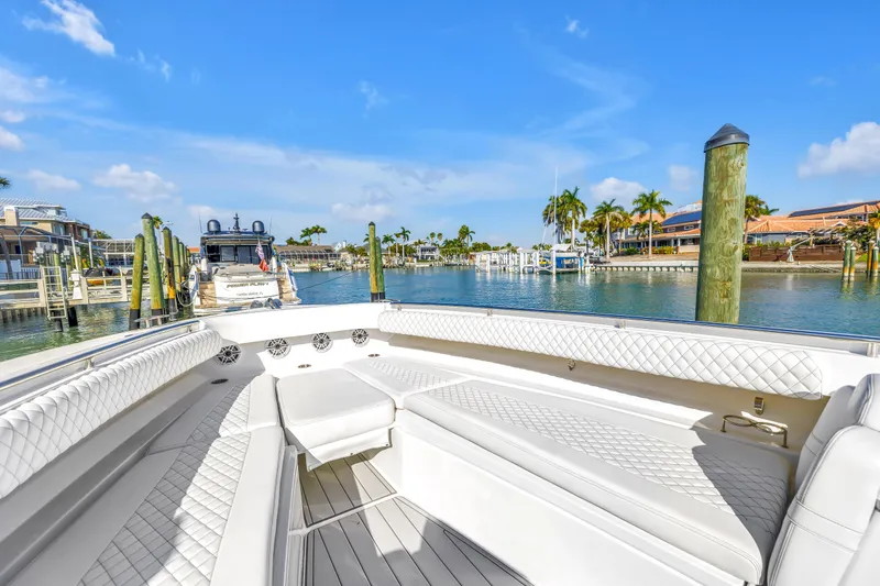 Slide: The Image of 2023 HCB 53 Suenos RXV luxury boat interior at marina with palm trees. - 99