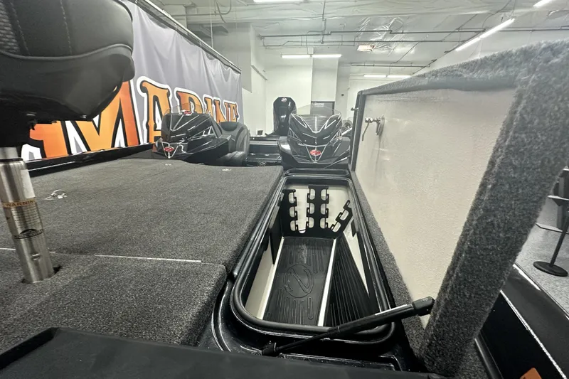 Slide: The Image of 2022 Ranger Z521L boat interior with open storage compartment and seating. - 10