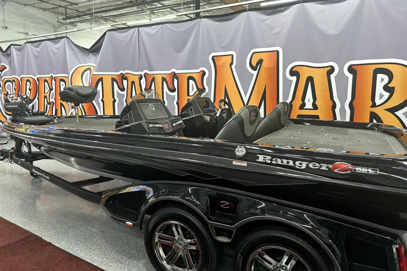 Slide: The Image of 2022 Ranger Z521L boat displayed indoors with bold signage backdrop. - 18