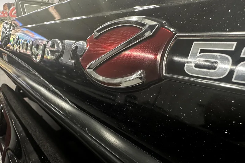 Slide: The Image of 2022 Ranger Z521L boat emblem with metallic finish and red accents. - 22