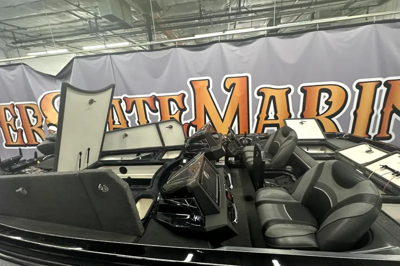 Slide: The Image of 2022 Ranger Z521L boat interior with open storage compartments and dual seats. - 23