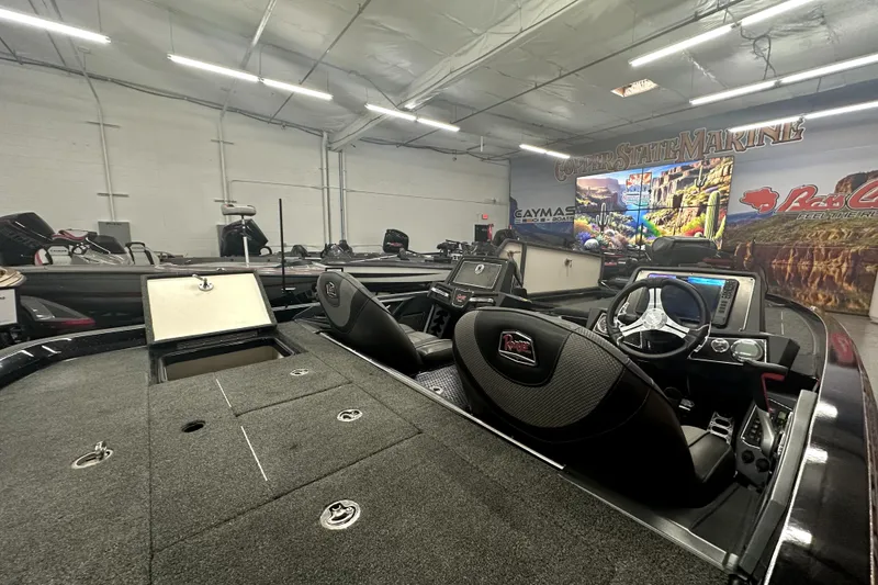 Slide: The Image of 2022 Ranger Z521L boat interior in showroom with advanced dashboard and seating. - 24