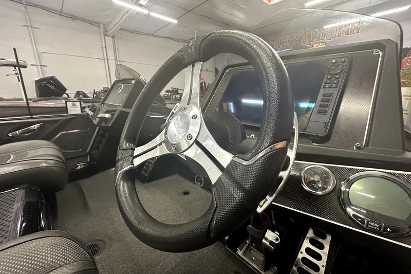 Slide: The Image of 2022 Ranger Z521L boat interior with steering wheel and dashboard controls. - 27