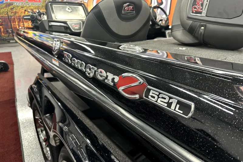 Slide: The Image of 2022 Ranger Z521L boat, sleek black design with logo detail. - 29