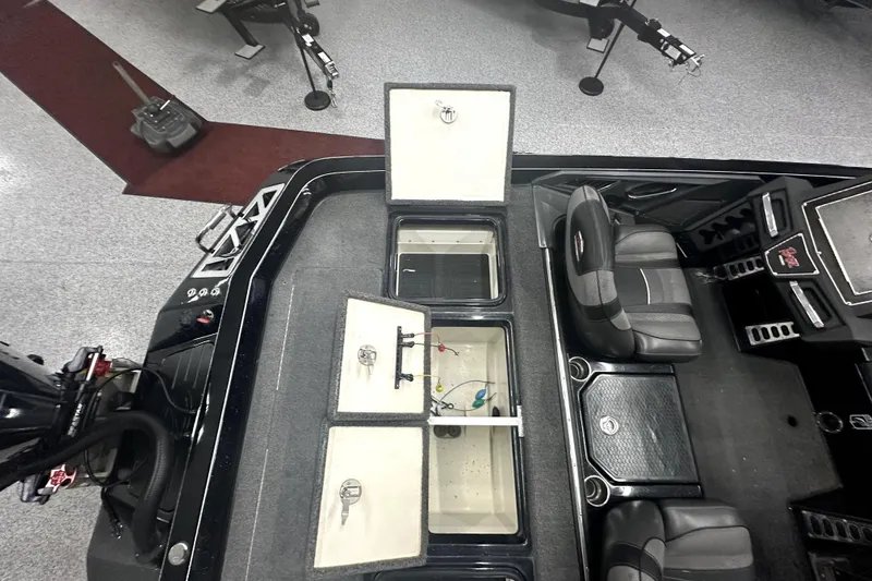 Slide: The Image of 2022 Ranger Z521L boat interior with open storage compartments and seating. - 31