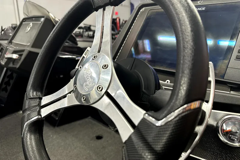 Slide: The Image of Steering wheel and dashboard of 2022 Ranger Z521L boat, featuring modern controls. - 35