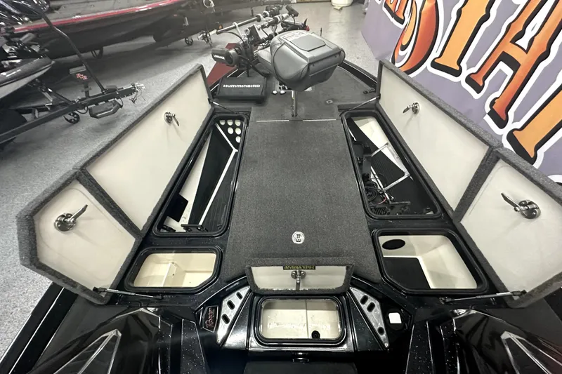 Slide: The Image of 2022 Ranger Z521L boat interior with open storage compartments and fishing equipment. - 38