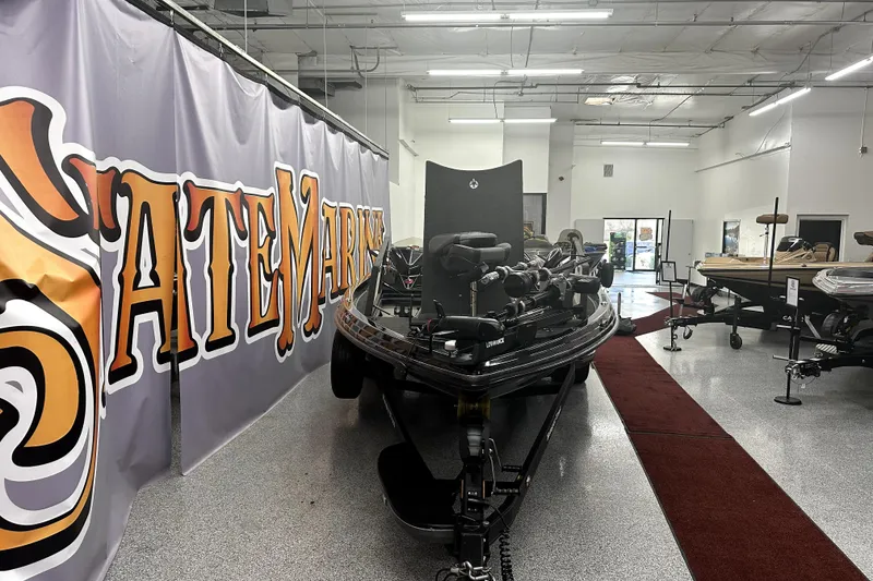 Slide: The Image of 2022 Ranger Z521L boat displayed in a showroom with a large banner. - 4