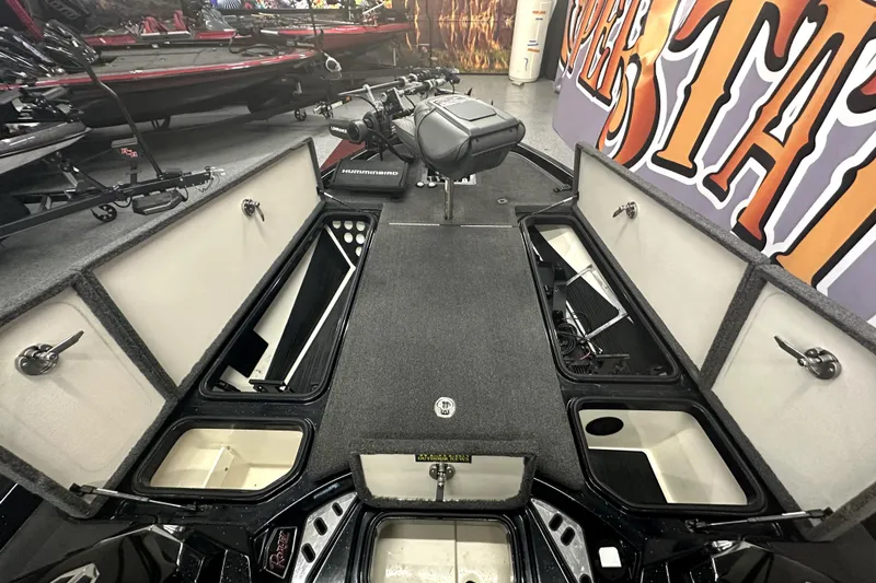 Slide: The Image of 2022 Ranger Z521L boat interior with open storage compartments and fishing equipment. - 42