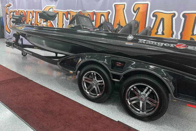Slide: The Image of 2022 Ranger Z521L boat with sleek black design and dual axle trailer. - 49