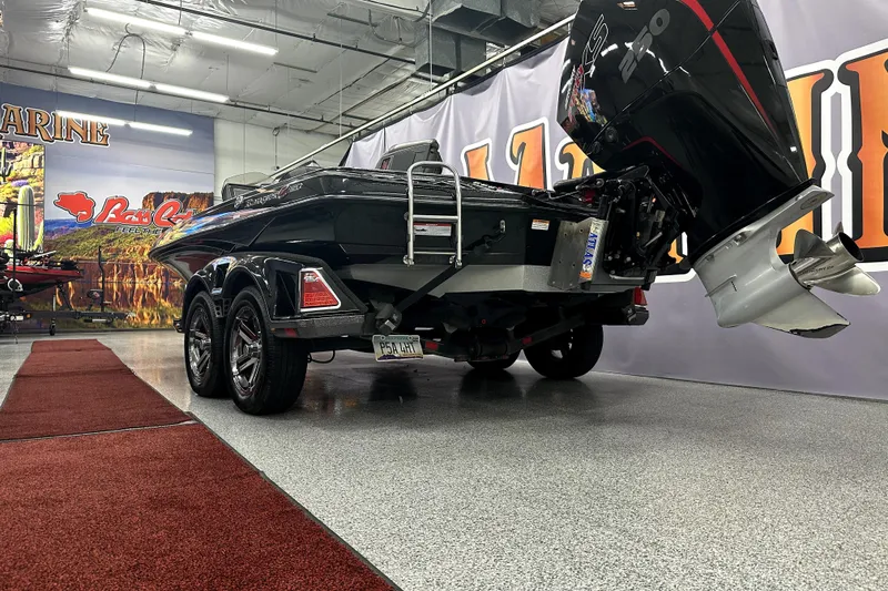 Slide: The Image of 2022 Ranger Z521L boat in showroom, featuring powerful outboard motor and sleek design. - 54