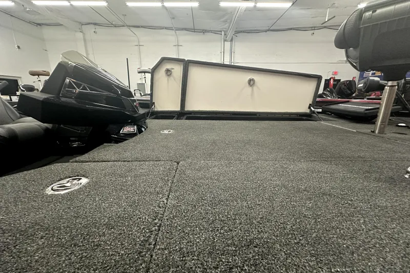 Slide: The Image of 2022 Ranger Z521L boat interior with open storage compartments in a showroom. - 58