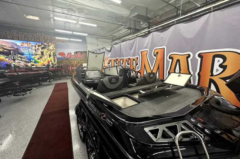 Slide: The Image of 2022 Ranger Z521L boat displayed in a showroom with vibrant wall graphics. - 65