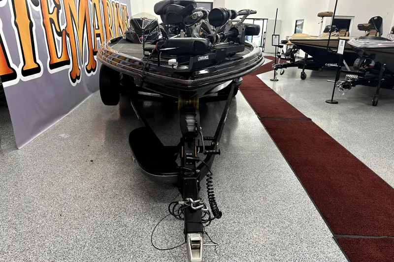 Slide: The Image of 2022 Ranger Z521L boat on display in showroom with red carpet and signage. - 66