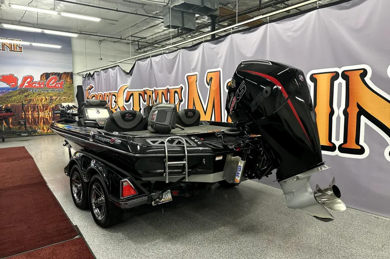 Slide: The Image of 2022 Ranger Z521L boat displayed indoors with powerful outboard motor. - 68