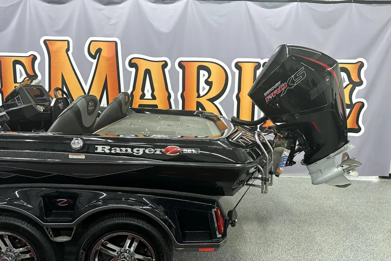 Slide: The Image of 2022 Ranger Z521L boat with Mercury Pro XS engine displayed indoors. - 7