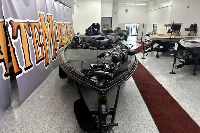 Slide: The Image of 2022 Ranger Z521L boat displayed in a showroom with other boats. - 70