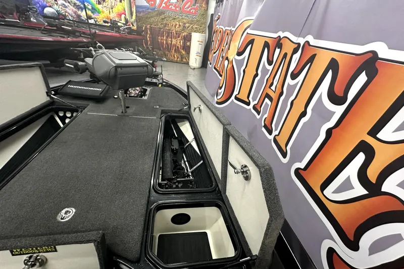 Slide: The Image of 2022 Ranger Z521L boat interior with storage compartments and fishing equipment. - 73