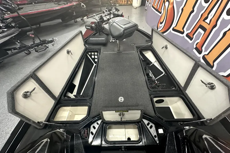 Slide: The Image of 2022 Ranger Z521L boat interior with open storage compartments and fishing equipment. - 9