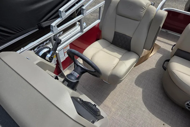 Slide: The Image of 2026 Sun Tracker Party Barge 18 DLX interior with steering wheel and seating. - 10