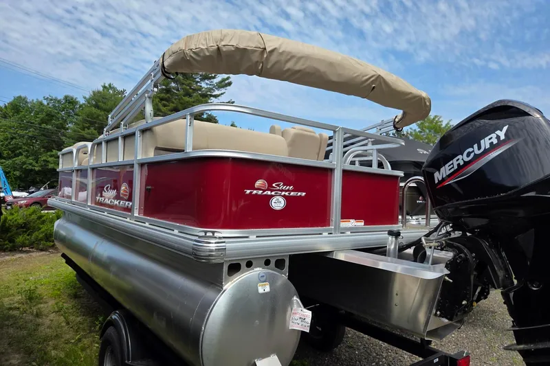 Slide: The Image of 2026 Sun Tracker Party Barge 18 DLX pontoon boat with Mercury engine, red exterior. - 5