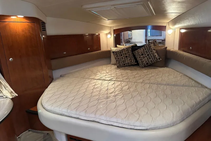 Slide: The Image of Luxurious cabin interior of 2006 Sea Ray 340 Sundancer with cozy bedding and ambient lighting. - 15