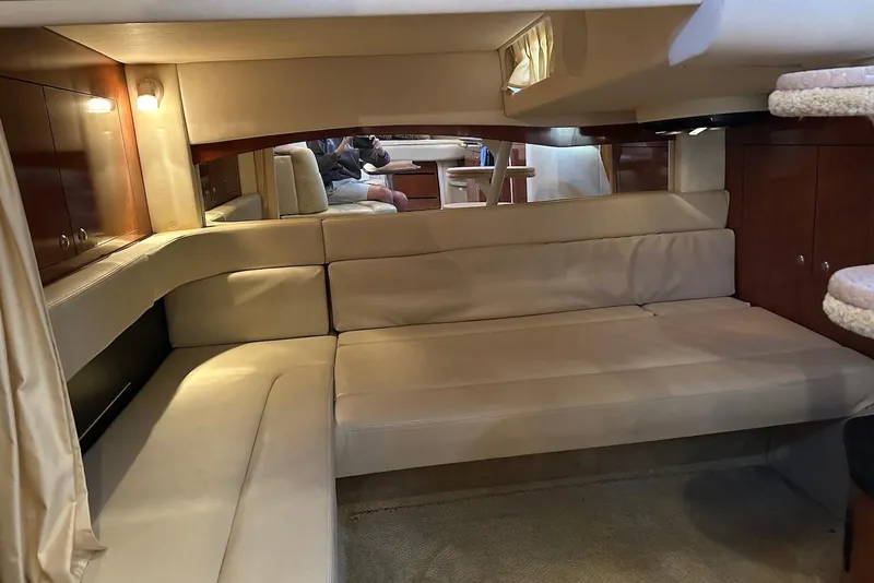 Slide: The Image of Interior of 2006 Sea Ray 340 Sundancer yacht with beige seating and wooden accents. - 16