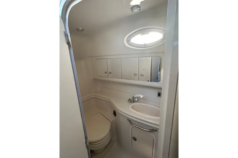 Slide: The Image of Bathroom interior of 2006 Sea Ray 340 Sundancer yacht, featuring sink and storage cabinets. - 17