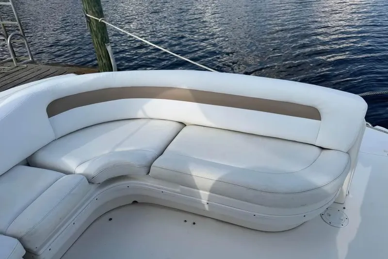 Slide: The Image of 2006 Sea Ray 340 Sundancer boat docked, featuring spacious seating and elegant design. - 3