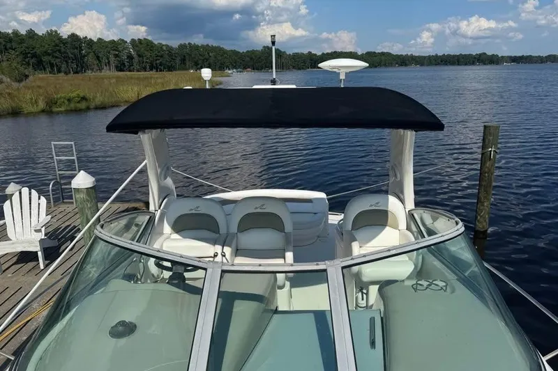 Slide: The Image of 2006 Sea Ray 340 Sundancer boat interior with white seating and water view. - 5