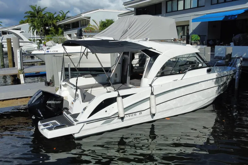 Slide: The Image of 2022 Beneteau Antares 8 boat docked, featuring a sleek design and Mercury outboard motor. - 14