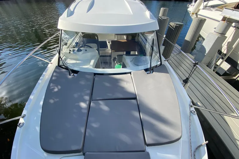 Slide: The Image of 2022 Beneteau Antares 8 boat with cushioned deck, docked at marina. - 15