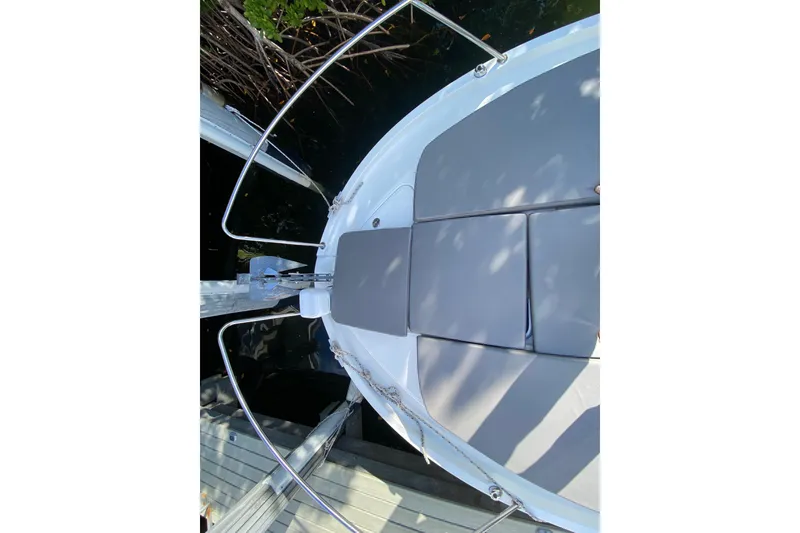 Slide: The Image of Beneteau Antares 8 (2022) boat deck with cushioned seating, docked by water. - 17