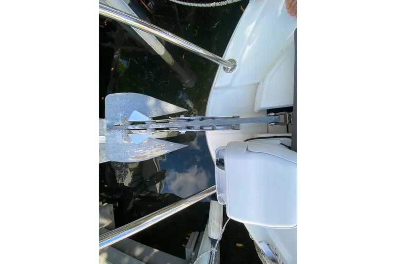 Slide: The Image of Beneteau Antares 8 (2022) boat anchor and deck details, docked on calm water. - 19