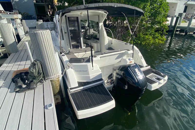 Slide: The Image of 2022 Beneteau Antares 8 docked, featuring Mercury outboard motor and sleek design. - 21