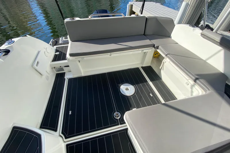 Slide: The Image of Beneteau Antares 8 (2022) boat interior with cushioned seating and sleek flooring. - 24