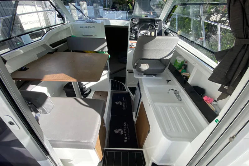 Slide: The Image of Interior of 2022 Beneteau Antares 8 boat with seating, table, and kitchenette. - 25
